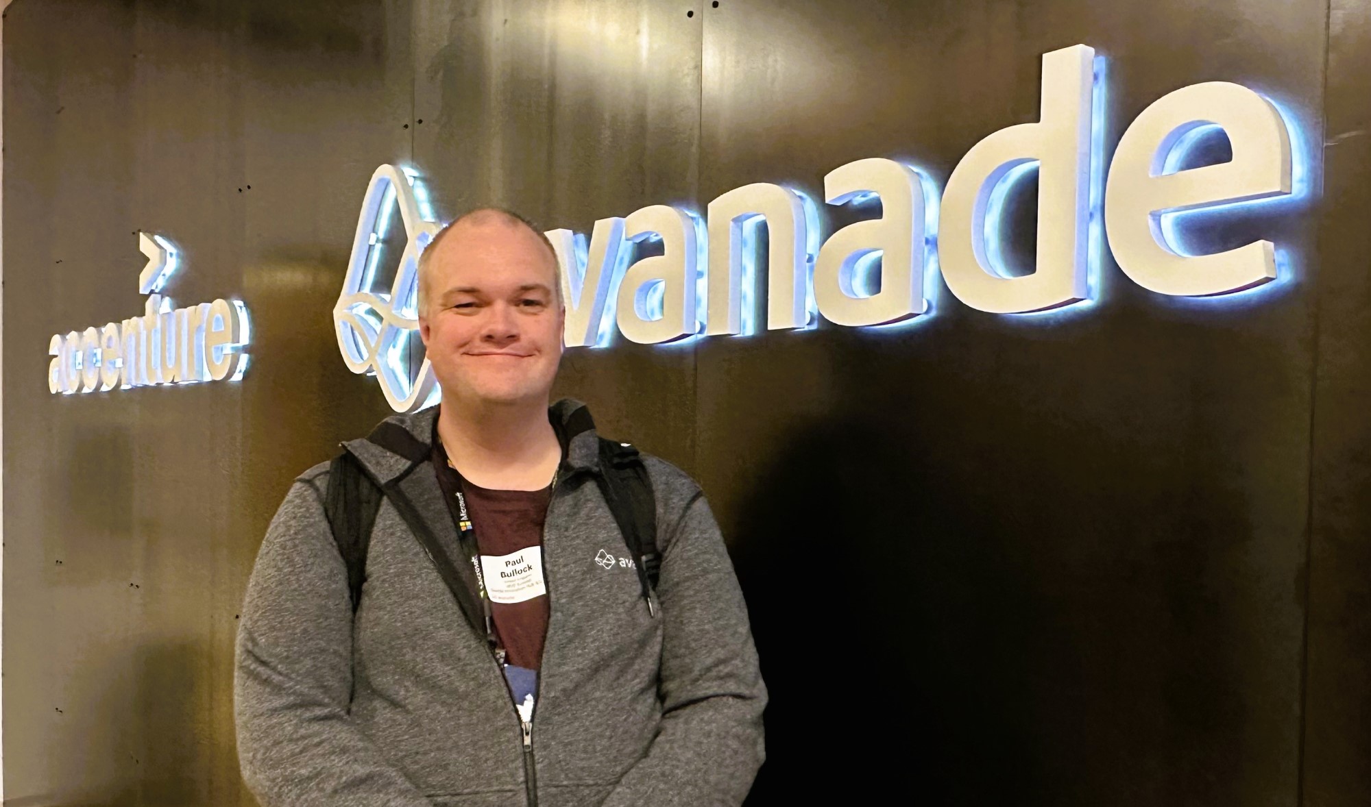 Visiting the Avanade Office and standing in front of the company logo